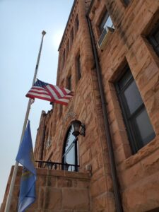 Flag at half mast in front of courthouse